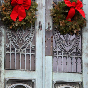 Pine bow wreathes on ornate, weathered copper doors in Oakland Cemetery. Canon EOS Rebel T3i. Pine bow wreathes on ornate, weathered copper doors in Oakland Cemetery. Canon EOS Rebel T3i.