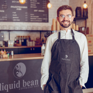 Liquid bean cafe signage and employee apron. Liquid bean cafe signage and employee apron.