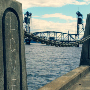 Simple graffiti on a river break wall post along the St. Croix River walk. Photography: Stillwater, MN. Simple graffiti on a river break wall post along the St. Croix River walk.