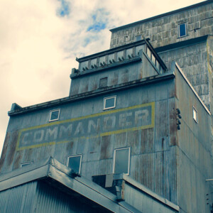 Old grain elevator, built in 1898, rises up against a cloud-filled blue sky. Photography: Stillwater, MN. Old grain elevator, built in 1898, rises up against a cloud-filled blue sky.