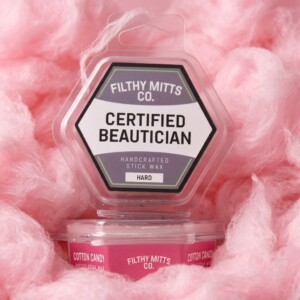 Actual photo of product with updated labeling/packaging processed through Kive.ai to generate realistic themed environment product images. Filthy Mitts Co. Certified Beautician Stick Wax