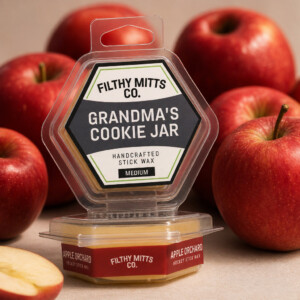 Actual photo of product with updated labeling/packaging processed through Kive.ai to generate realistic themed environment product images. Filthy Mitts Co. Grandma's Cookie Jar Stick Wax