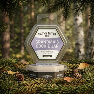 Actual photo of product with updated labeling/packaging processed through Kive.ai to generate realistic themed environment product images. Filthy Mitts Co. Grandma's Cookie Jar Stick Wax