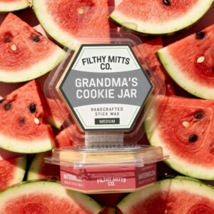 Actual photo of product with updated labeling/packaging processed through Kive.ai to generate realistic themed environment product images. Filthy Mitts Co. Grandma's Cookie Jar Stick Wax